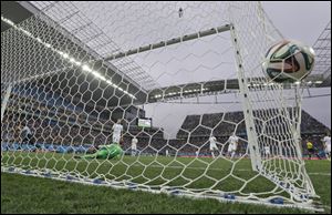 Uruguay's Luis Suarez, left, celebrates scoring the opening goal past England's goalkeeper Joe Hart today at Itaquerao Stadium in Sao Paulo, Brazil.