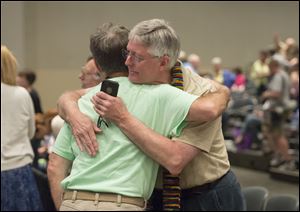 Gary Lyon, of Leechburg, Pa., left, and Bill Samford, of Hawley, Pa.., celebrate after a vote allowing Presbyterian pastors discretion in marrying same-sex couples at the 221st General Assembly of the Presbyterian Church.