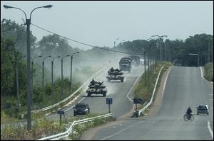 Pro-russian troops in tanks, several armored vehicles, and tracks drive on a road in the direction of Donetsk not far from Debaltseve, Donetsk region, eastern Ukraine, today.