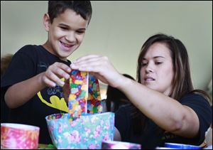 Isaac Dandra, 8, left, makes a Duck Tape basket with his sister Hannah Dandra, right, both from Lorain, Ohio, at a workshop during the 11th annual Duck Tape Festival on June 14 at Veterans Memorial Park in Avon, Ohio.