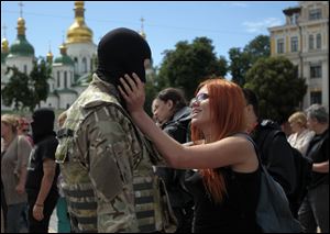 A woman says goodbye to her friend, a volunteer, before they were sent to the eastern part of Ukraine to join the ranks of special battalion 