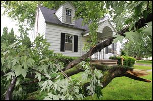 A large limb and other branches pile up in the yard at 833 Hanson St. in Northwood. While residents may be weary of the above-average rainfall for June, it was the wind that damaged property.