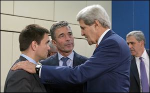 Ukrainian Foreign Minister Pavlo Klimkin, left, speaks with NATO Secretary General Anders Fogh Rasmussen, center, and U.S. Secretary of State John Kerry, second right, during a meeting of the NATO-Ukraine Commission at NATO headquarters in Brussels today.