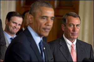 House Speaker John Boehner, R-Ohio, right, watches President Barack Obama speak at a golf-related ceremony today. 