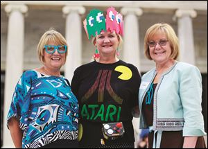 Pat Tipton, left, Kelly Sheehan, center, and Carol Bintz attend the Art of Video Games exhibit reception and grand opening at the Toledo Art Museum.   