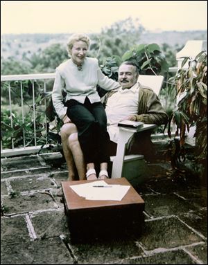 In this 1948 photo, writer Ernest Hemingway sits with his fourth wife, Mary, in Cuba. 