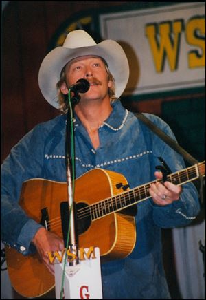 In this undated photo provided by Paul Eckhart, Alan Jackson performs at the Opry House, in Nashville, Tenn.