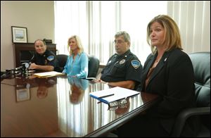 ProMedica Bay Park Hospital president Holly Bristoll, right, speaks as from left, Oregon Police Chief Mike Navarre, Sgt. Kelly Thibert, and Assistant Chief Paul Magdich listen during a news conference at the Oregon Police Department  concerning the outcome of a criminal investigation into a data breach at the hospital.