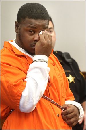 Tyrone Hoskins, Jr., wipes a tear from his eye while entering his guilty plea Monday to reckless homicide with a firearms specification in the Feb. 2 shooting death of Michael Williams during a chaotic scene outside an after-hours club.