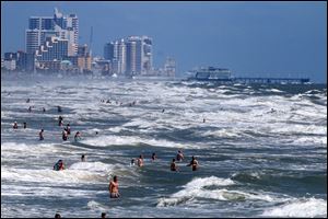 People deal with the high surf and currents off Daytona Beach generated by Tropical Storm Arthur on Tuesday. 