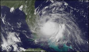 A satellite image released by the National Oceanic and Atmospheric Administration Tuesday, shows the center of Tropical Storm Arthur off the east coast of Florida. 