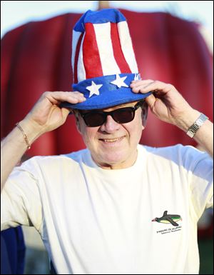 Denny Brown of Florida poses for a portrait with his America-themed hat at the Star Spangled Banner celebration held at Fort Meigs in Perrysburg, Ohio.