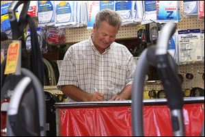 Mike Janiszewski, Jr., fills out a repair slip for a customer at  the Fix It Shop in North Toledo. Mr. Janiszewski is the owner of the shop, a vacuum seller and repair store in North Toledo, which has been operating at its current location since 1964. Originally opened in 1926 as a small appliance repair and sale shop, Mr. Janiszewski began working for his father at the store in 1969, making $1 an hour.