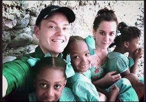 Allen Freeman, left, and Aubrey Crosby visited an orphanage during a Decemeber visit to Les Cayes, Haiti. Mr. Freeman, a pilot, helped arrange air travel.