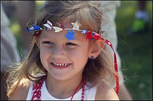 Aubrey Gemuenden, 4, of Twinsburg is decked out in patriotic regalia. The village’s celebration included live music and pie, singing, and beard competitions.