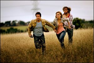 From left,  Mark Wahlberg as Cade Yeager, Nicola Peltz as Tessa Yeager, and T.J. Miller as Lucas Flannery, in 