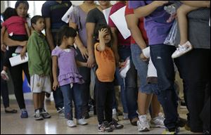 Immigrants who entered the U.S. illegally stand in line for tickets at the bus station after they were released from a U.S. Customs and Border Protection processing facility in McAllen, Texas. The immigrants entered the country through an area referred to as zone nine.