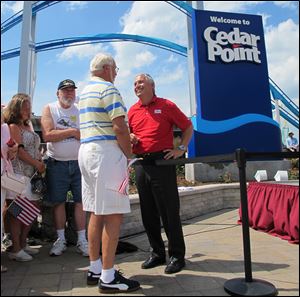 Matt Ouimet, chief executive of Cedar Fair Entertainment Co., greets a guest at Cedar Point amusement park.