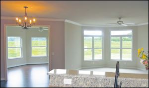 Transoms allow extra sunlight into this open design great room. 