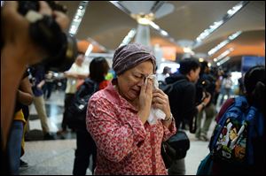 A woman reacts to news about Malaysia Airlines Flight 17 at Kuala Lumpur International Airport in Sepang, Malaysia.