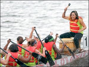 Angelica Diokno, right, beats a drum to get her team from Harbor rowing together.
