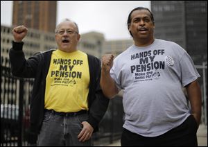 Detroit retirees Mike Shane, left, and William Davis protest near the federal courthouse in Detroit earlier this month.