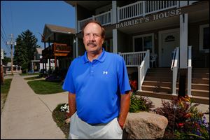Denny Rectenwald stands in front of his business Harriet's House at Put-in-Bay. Mr. Rectenwald is upset with the Put-in-Bay police department after recently being handcuffed after being stopped for a traffic violation.