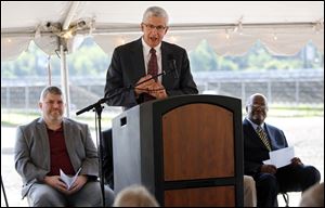 Bill Rudolph, chairman of the Rudolph/Libbe Companies, speaks during the dedication of a 2.1-megawatt solar array Tuesday.  Jeff Sailer, executive director of the Toledo Zoo, left, and Jerry Jones, CEO of the Woodlands Consulting Group, right, listen. 