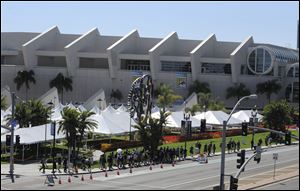 Fans walk past the Hall H line-up area outside the San Diego Convention Center as they head to the Preview Night event on Day 1 of the 2013 Comic-Con International Convention in San Diego.