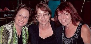 Enjoying the fund-raiser for Toledo Northwestern Ohio Food Bank are Laurie Cohen, left, with Black Swamp Blues Society members Cheryl Christy, center, and Linda Deubner.
