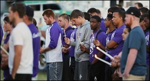People attend a vigil on Thursday for Cory Barron, whose manner of death remains a mystery,  at Fremont Ross High School.
