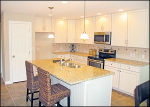 The efficient kitchen includes a stainless stove and built-in microwave, as well as a dishwasher.