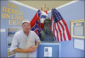 Dan Savage stands near a sculpture of abolitionist John Brown at the Lake Erie Islands Historical Society.