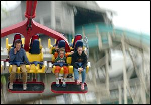 People ride the Skyhawk at Cedar Point amusement park in Sandusky. The ride has been closed indefinitely after a cable snapped, injuring two visitors. Cedar Point spokesman Bryan Edwards says a cable on one of the Skyhawk ride's carriages disconnected late Saturday.