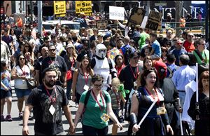 Crowds cross the street outside the convention center on Day 3 at the 2014 Comic-Con International Convention held Saturday in San Diego.