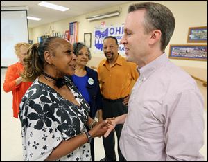 Democratic candidate for governor Ed FitzGerald greets United Auto Workers member Janice Fryer at the IBEW Local 8 in Rossford. The AFL-CIO hosted the event Monday for the Cuyahoga County executive.