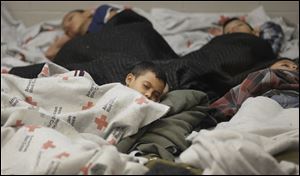 Detainees sleep in a holding cell at a U.S. Customs and Border Protection, processing facility in Brownsville,Texas, in June. The Border Patrol has detained more than 57,000 unaccompanied children since October.