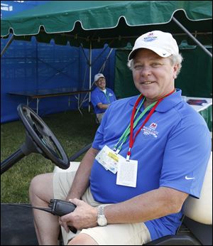 Rick Sabin, director of spectator services for Highland Meadows Golf Club sits in a golf cart during the tournament.