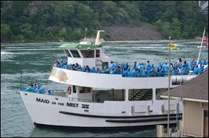 With passengers clad in ponchos to keep dry, the Maid of the Mist pulls away from the docks for a 20-minute excursion along the bottom of the American Falls and the larger Horseshoe Falls on the Canadian side.