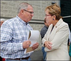 Toledo Mayor D. Michael Collins speaks with U.S. Rep. Marcy Kaptur outside the Lucas County Emergency Management Agency building.
