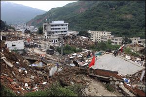 Rescue workers search for survivors among the remains of collapsed buildings in the epicenter of an earthquake that struck the town of Longtoushan in Ludian county in southwest China's Yunnan province today.