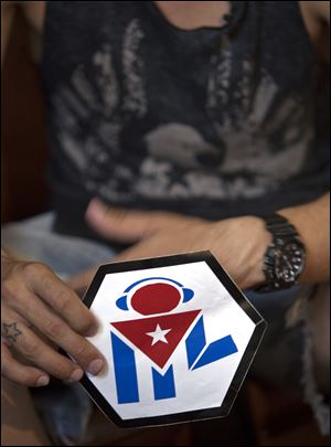 Manuel Barbosa, 25, shows the logo of his 