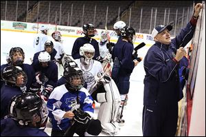 Walleye coach Derek Lalonde, right, lays out directions for a drill to a group of youth hockey players during a session on Wednesday at Huntington Center. 