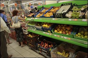 People buy imported fruit at a supermarket in downtown Moscow today. The Russian government has banned all imports of meat, fish, milk and milk products and fruit and vegetables from the United States, the European Union, Australia, Canada and Norway.