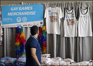 A man looks over Gay Games t-shirts for sale in the downtown convention center in Cleveland Thursday.
