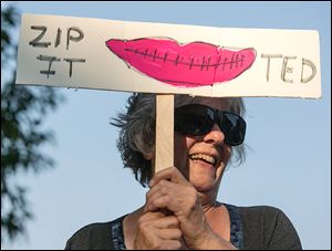Carole Jambard-Sweet of Maumee protests outside the Ted Nugent concert.