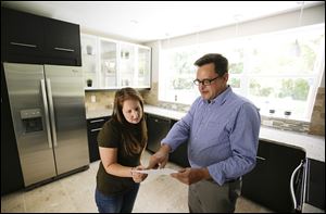 Realtor Greg Gammonley, right,  shows off a home to  Maddie Coker in Orlando, Fla. A report suggests that the recession did little to turn off millennials from the idea of owning a home.