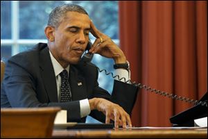 President Barack Obama listens during a phone call with Jordan's King Abdullah II in the Oval Office of the White House on Friday in Washington.