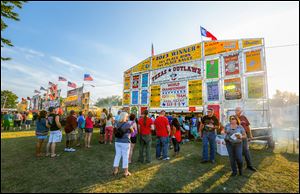 Lines form for food during the 31st annual Northwest Ohio Rib-Off at the Lucas County Fairgrounds in Maumee. More than 60,000 people attended the event over its four-day run. The event ended Sunday with free admission courtesy of CedarCreek Church.