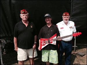 Mike Mori, director of the Northwest Ohio Rib-Off and director of sales for The Blade, is flanked by Ronald Schramm, left, and Bob Baker from the Blue Diamonds Detachment Marine Corps League. Mr. Mori said attendance for the four-day event was about 60,000 people.